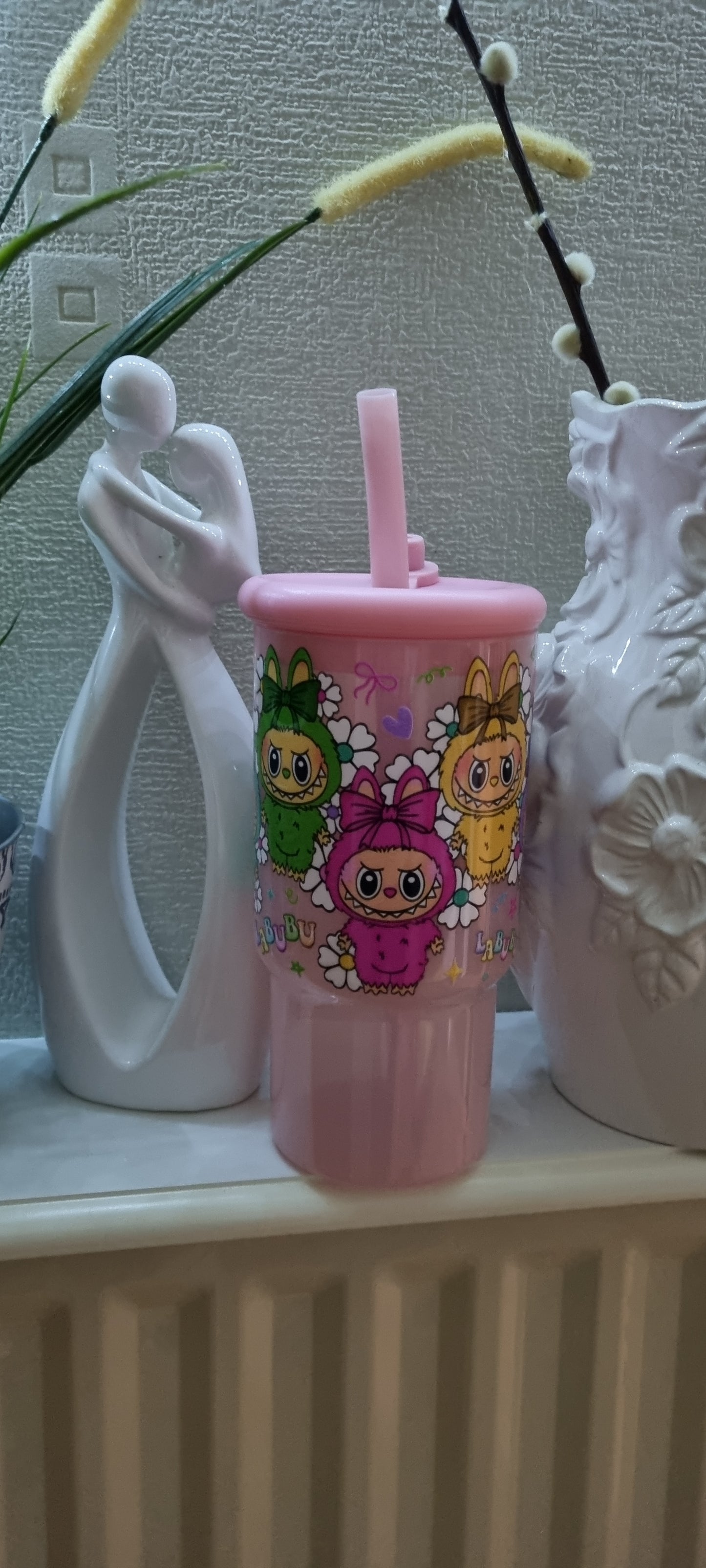 Pink cup with a large straw suitable for milkshakes and iced coffees.